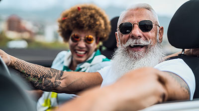 A mature couple enjoying their new convertible