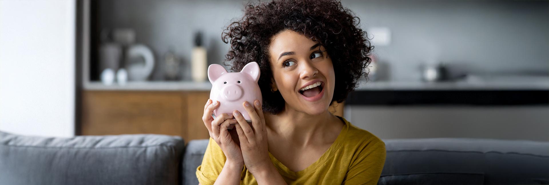 Woman holding a piggybank full of savings